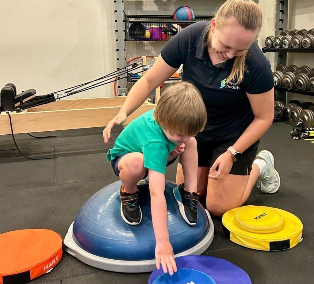 Lauren doing physio with paediatric client